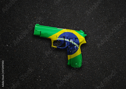 A handgun illustration with a Brazilian flag overlay to symbolize gun crime, suicide and murder with copy space photo