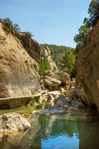 TERUEL, SPAIN, JULY 2016: view of the walkways in the river and the mountains in the tourist area of Matarraña