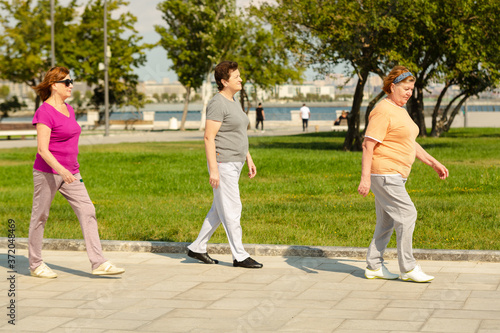Three women running in public park, having healthy lifestyle for immunity.