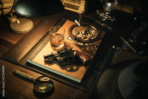 Film noir detective desktop with revolver photo
