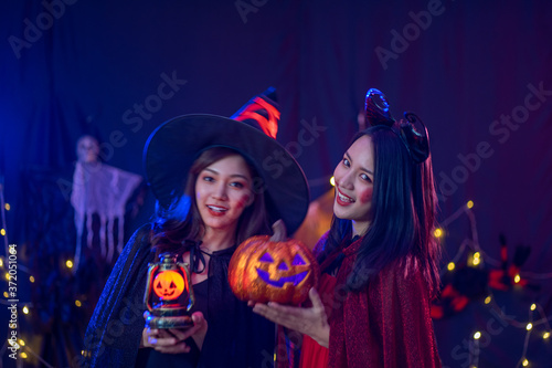 Asian women in witch costume in dark night forest scene. Halloween party concept. party art design concept.