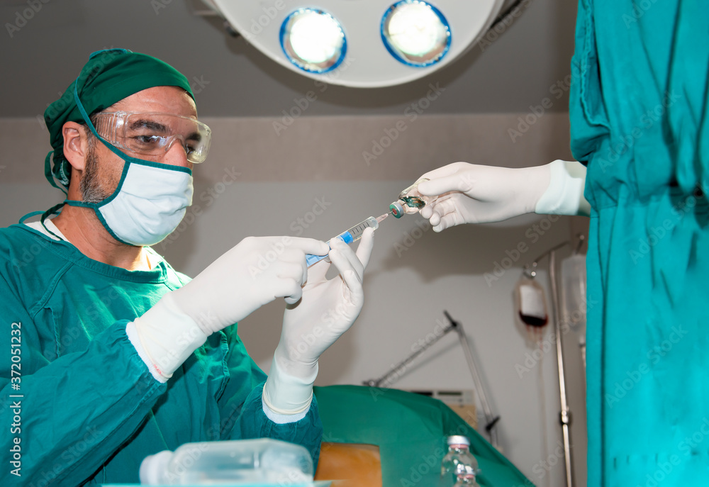 Senior anesthesiologist or doctor hold syringe prepare for injection in