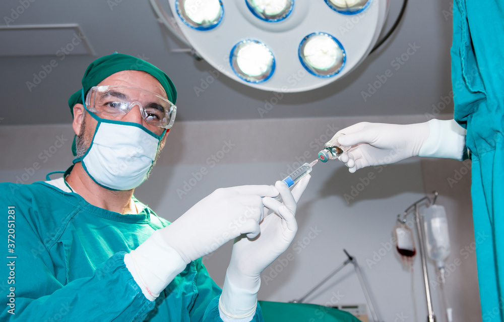 Senior anesthesiologist or doctor hold syringe prepare for injection in