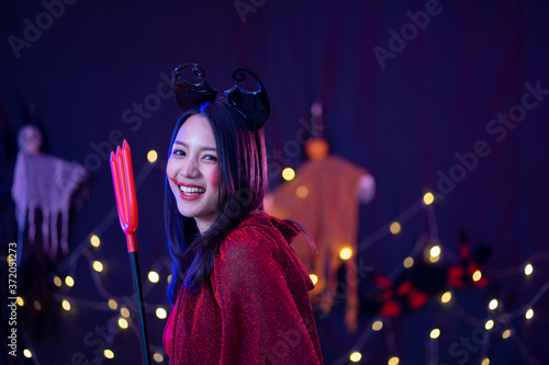 Asian women in witch costume in dark night forest scene. Halloween party concept.  party art design concept. photo