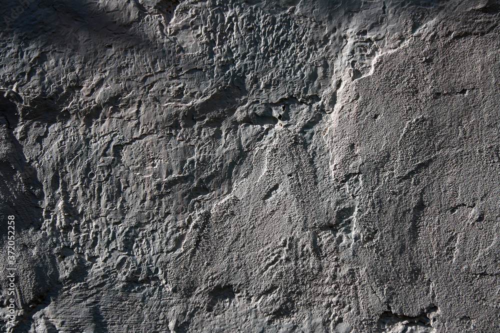 Fototapeta premium Grey textured plaster on an old wall. Background.