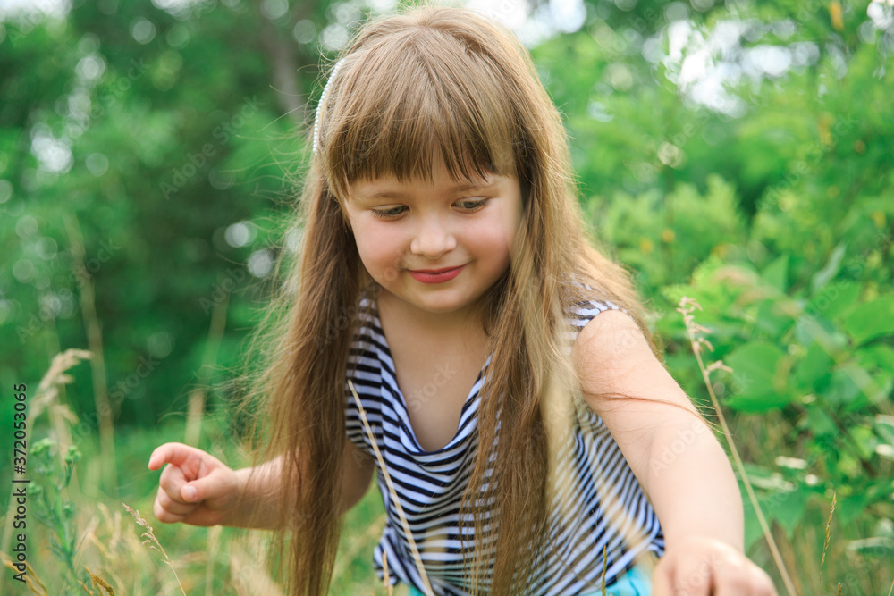 A little girl makes her way through the grass A little girl makes her way through the grass