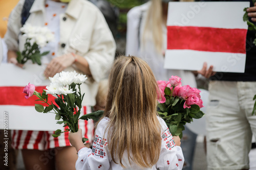 Details with a little girl holding flowers during a political rally supporting the protests in Belarus. photo