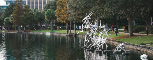 Bird monument artwork in a lake stroll through downtown Lake Eola on Orlando Florida on a fall winters afternoon on a weekend day.  photo