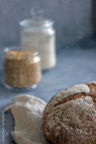 Loaf of sliced sourdough bread on a dark background, Close-up. Handmade Whole Grain Dark Bread