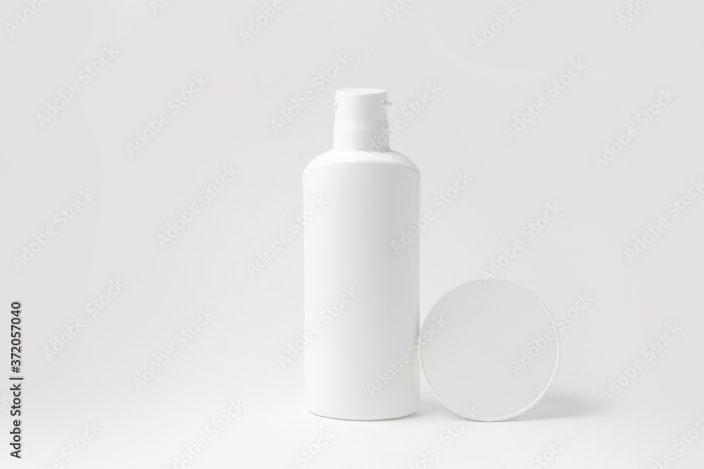 Set of white cosmetic bottles and jars on white background with place to add text Set of white cosmetic bottles and jars on white background with place to add text
