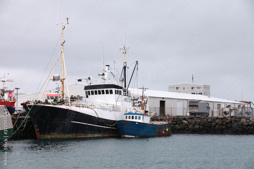 Trawlers are moored in port. Iceland
