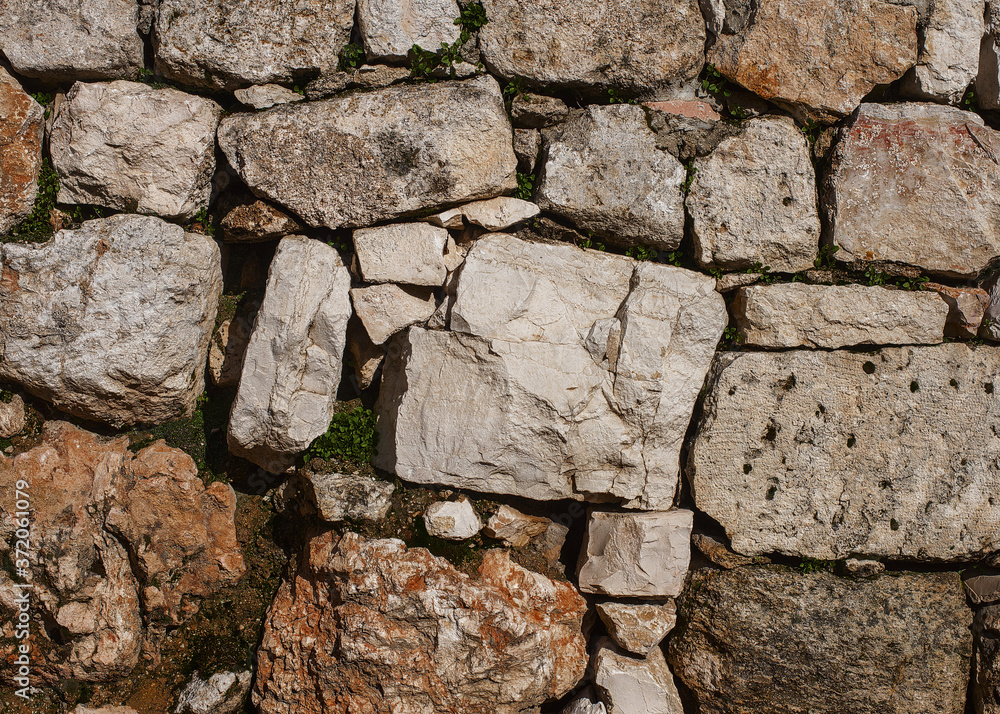 Fototapeta premium The ancient wall with rough stones, Jerusalem, old city.