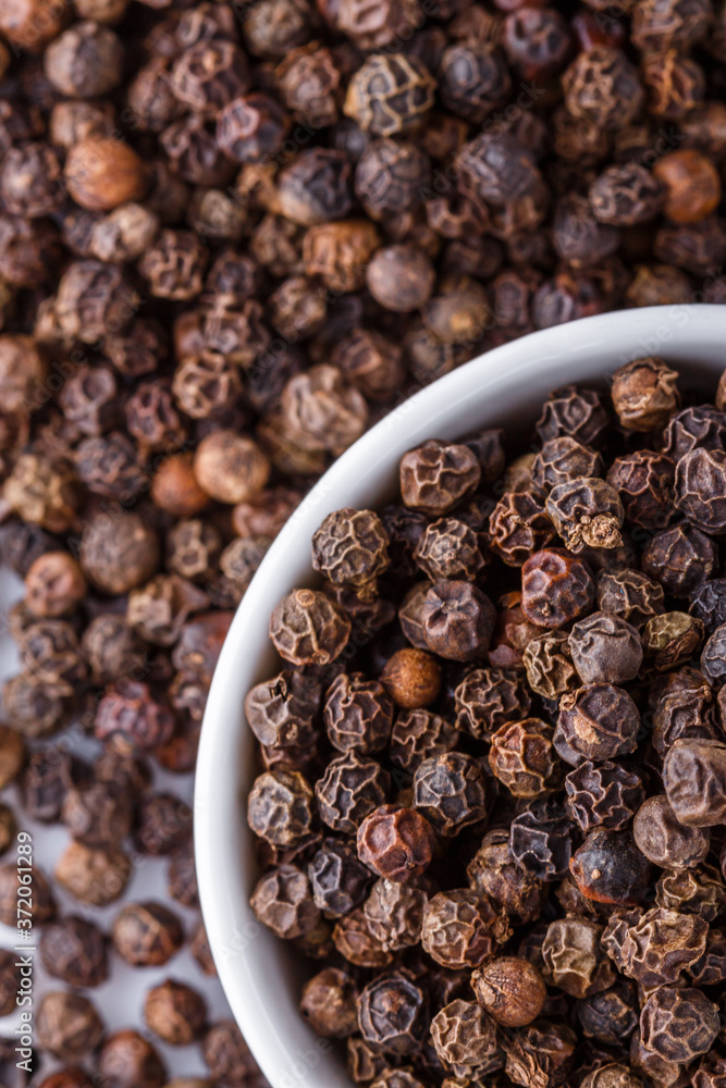 fragrant black pepper on white acrylic background fragrant black pepper on white acrylic background