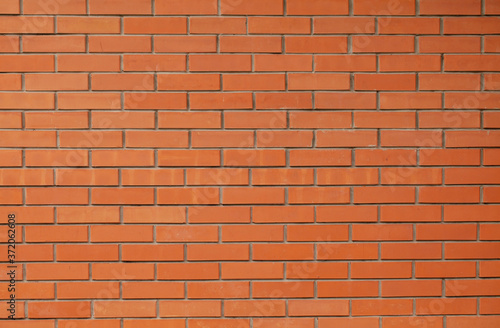 Brick red wall. Background of a new brick house.