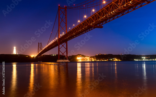 View of the Tagus River and the 25 of April Bridge (Ponte 25 de Abril) at night, in Lisbon, Portugal