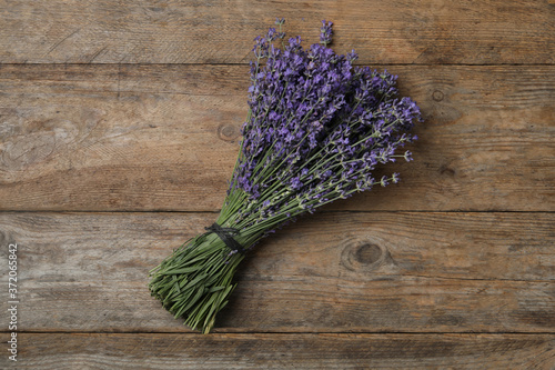 Beautiful lavender bouquet on wooden background, top view