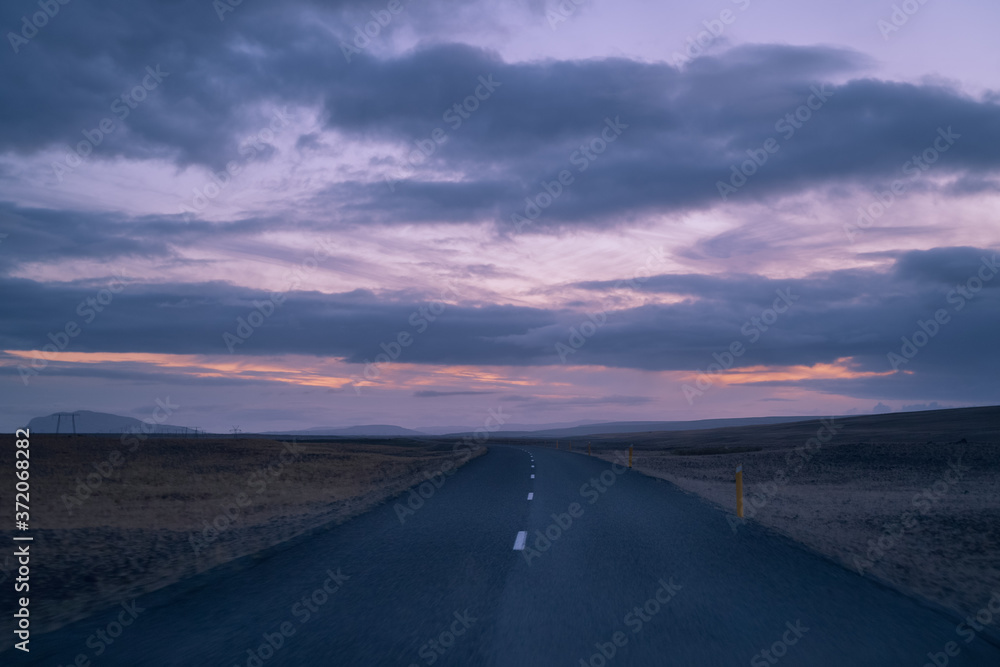 Iceland roads. Travel nature landscape. Drive on the road at sunset Iceland roads. Travel nature landscape. Drive on the road at sunset