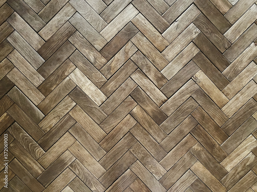 Classic wooden floor parquet texture as interior background. Natural herringbone floor texture photo
