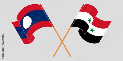 Crossed and waving flags of Laos and Syria