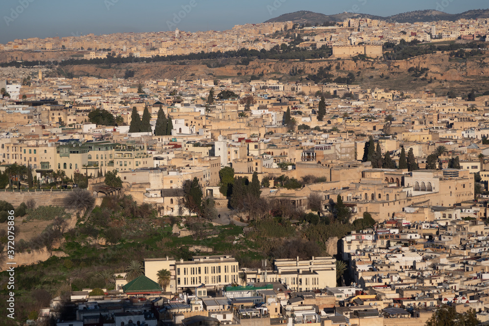 Fes Morocco cityscape with medina in centre seen from hills above in bright sun 