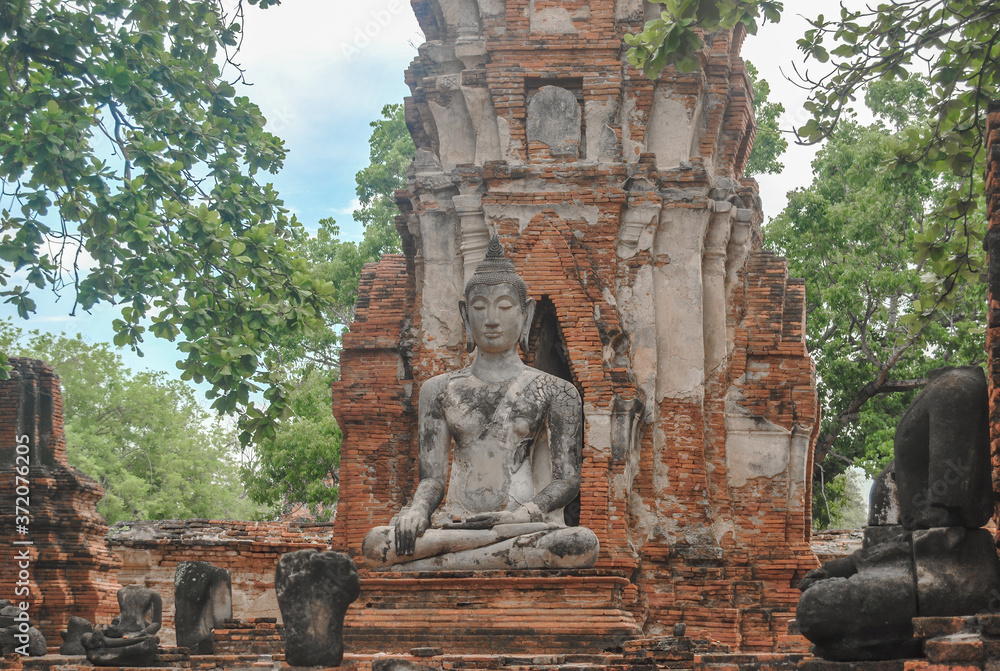Ancient Buddha statue in Wat Phra Mahathat temple, in Phra Nakhon Si, Ayutthaya Historical Park, Thailand.
