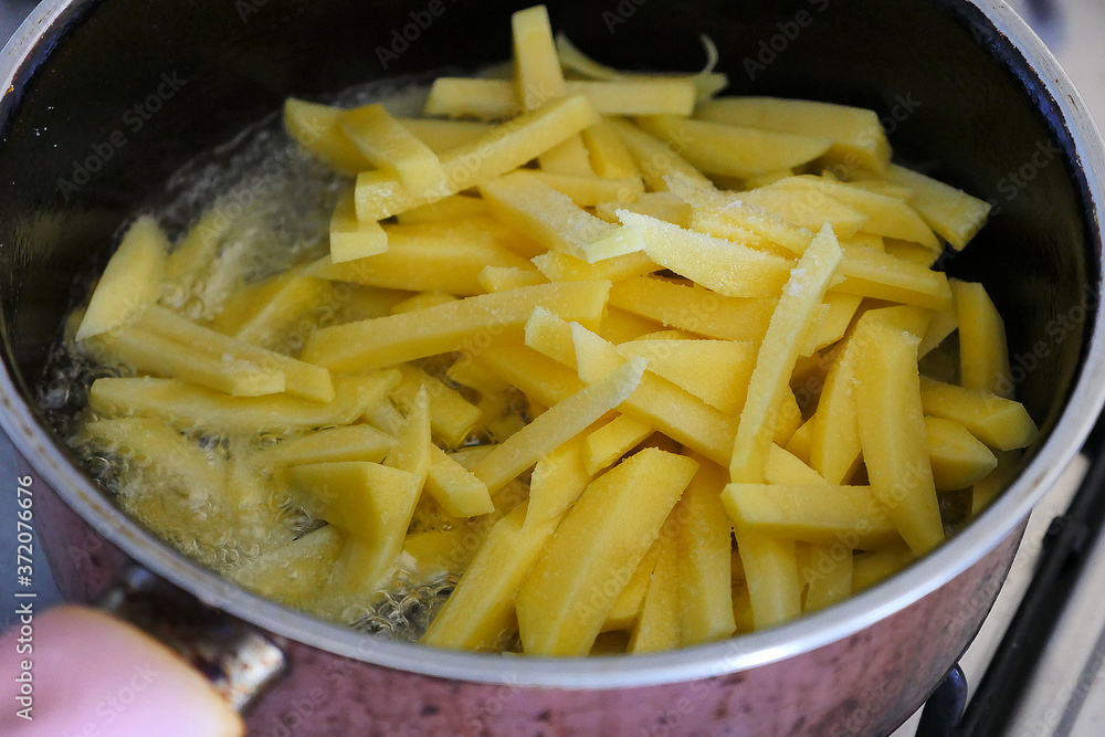 sliced potatoes fried in the pan French fries for breakfast in the morning sliced potatoes fried in the pan French fries for breakfast in the morning