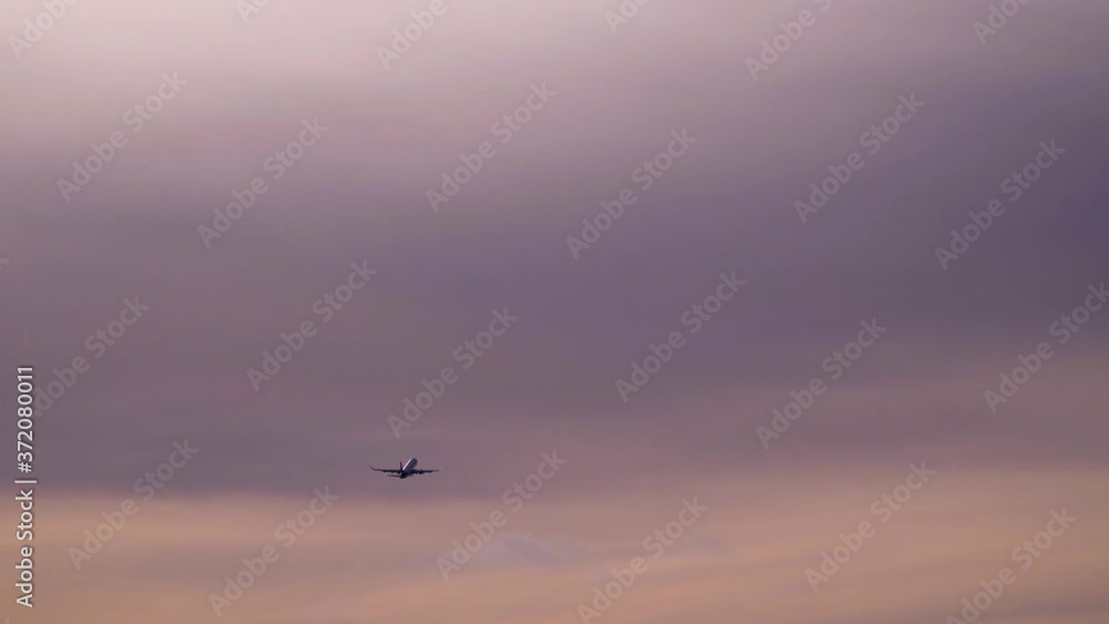 Plane is flying in sunset sky. Travel, vacation, air transport, transportation concept Plane is flying in sunset sky. Travel, vacation, air transport, transportation concept