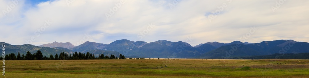 Nature panoramic of prairie and mountains