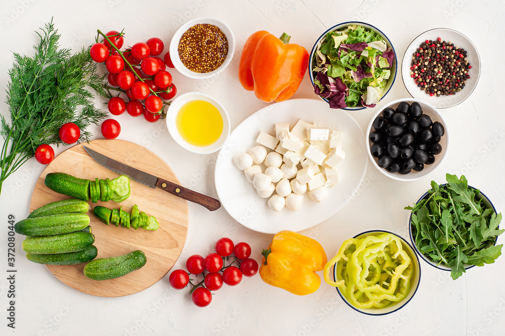 ingredients for summer vegetable salad with feta cheese and mustard on light concrete background. ingredients for summer vegetable salad with feta cheese and mustard on light concrete background.