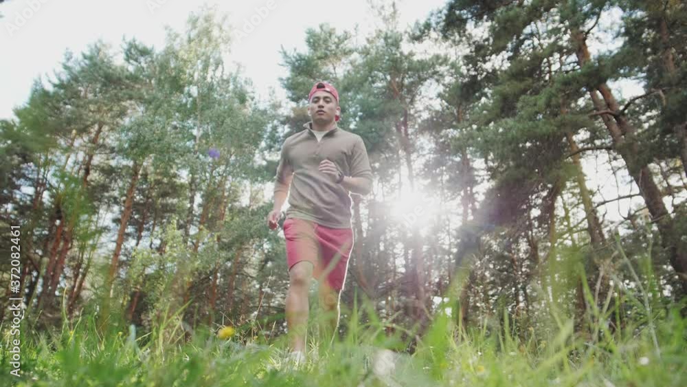 Athletic korean Asian man running outdoors. Action and healthy lifestyle concept. Runner cardio marathon training Athletic korean Asian man running outdoors. Action and healthy lifestyle concept. Runner cardio marathon training