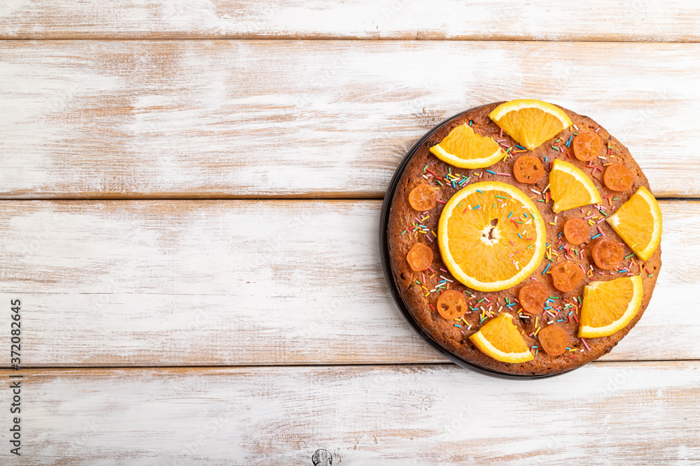 Orange cake on a white wooden background. Top view, copy space. Orange cake on a white wooden background. Top view, copy space.