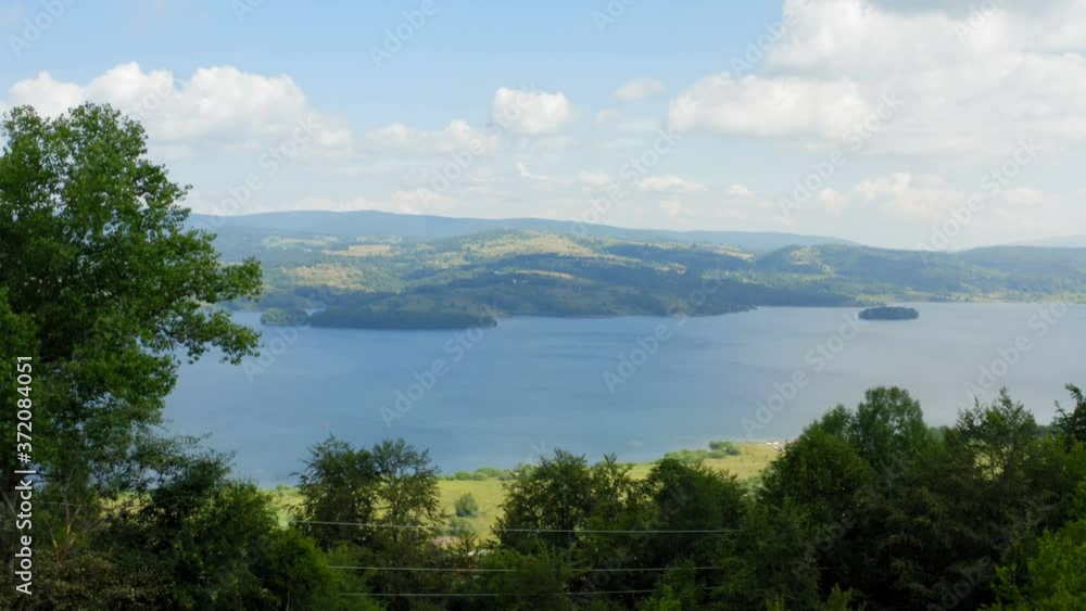 Flight with a drone near a coast of a beautiful lake with a scenic panorama on a cloudy sunny day Flight with a drone near a coast of a beautiful lake with a scenic panorama on a cloudy sunny day
