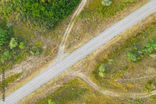Rural road between agriculture fields. Aerial view.