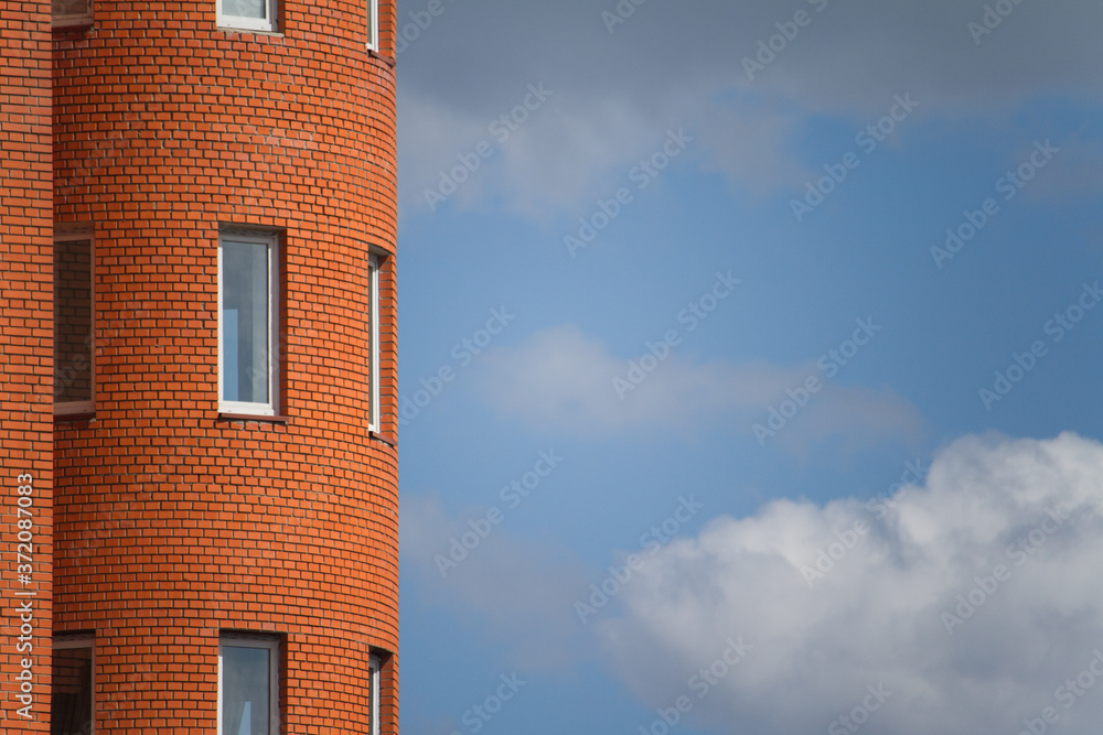 Close-up of architectural details and window of an old building against the blue sky, background or concept Close-up of architectural details and window of an old building against the blue sky, background or concept