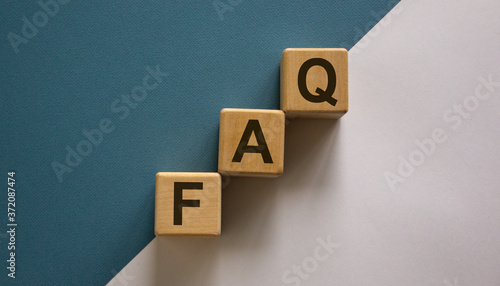 Concept word 'FAQ' on cubes on a beautiful white and blue background. Business concept.