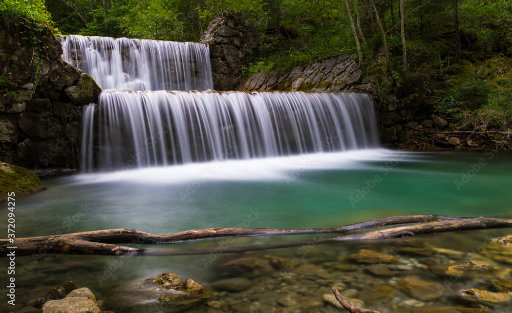 Fototapeta premium Waterfalls of river Vils, cloudy summer day, long exposure