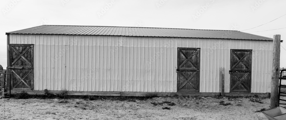 Fototapeta premium Rustic metal barn with wooden barn doors on a working ranch near Denver