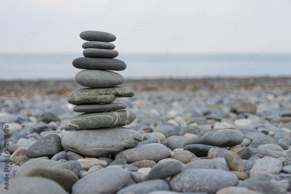 Pebbles Stack, Zen art, Rocks Tower, Pebbles tower build on the rocky beach, horizon where sky meets the sea, blurred background,
