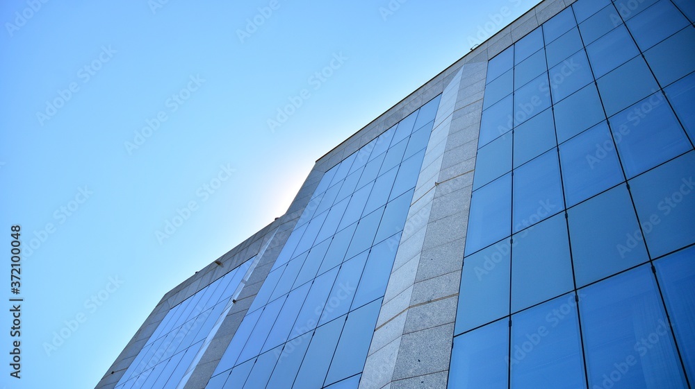 Glass curtain wall of modern office building. Modern office building on a clear sky background.
