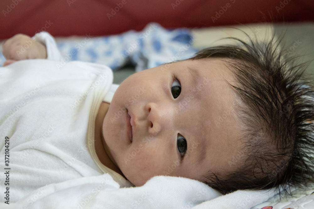Portraiture image of Asian Cute little baby boy lying on bed Portraiture image of Asian Cute little baby boy lying on bed