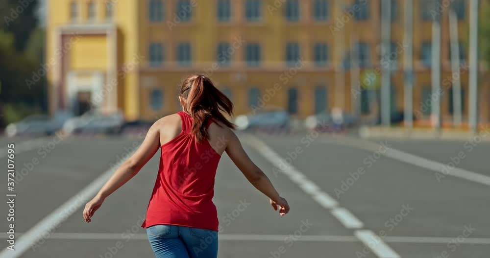 Beautiful girl is spinning on roller skates, balancing her arms. Girl is dancing on roller skates. Portrait view. 4k, 10bit, ProRes Beautiful girl is spinning on roller skates, balancing her arms. Girl is dancing on roller skates. Portrait view. 4k, 10bit, ProRes