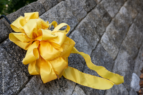 yellow ribbon on brick wall