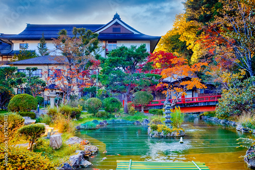 Japanese Religious Heritage. Japanese Monastery During Seasonal Red Maples and Pond With Lantern on Sacred Mount Koyasan in Japan.