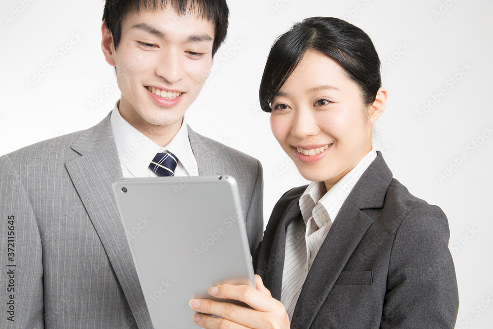 タブレットＰＣを見るビジネスマンとＯＬ