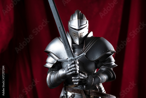 knight with sword and red velvet background