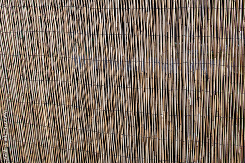 wooden fence the textures of the background of the reed fence is yellow brown bamboo