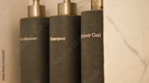Hotel bathroom supplies with shower gel, shampoo and conditioner in luxury hotel photo