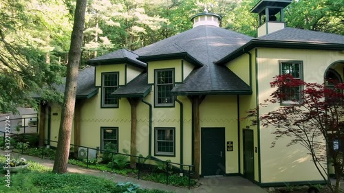 Aerial turn reveals Mt Gretna Playhouse, outdoor open air theater in wooded setting photo