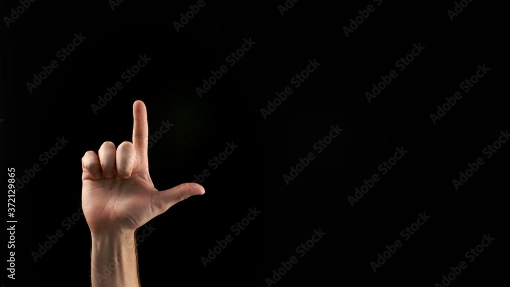 Hand showing letter L on dark background. Sign language alphabet Hand showing letter L on dark background. Sign language alphabet