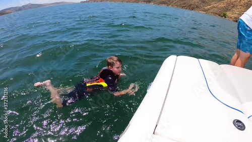 A kid knee boarding at Castaic Lake in California. photo